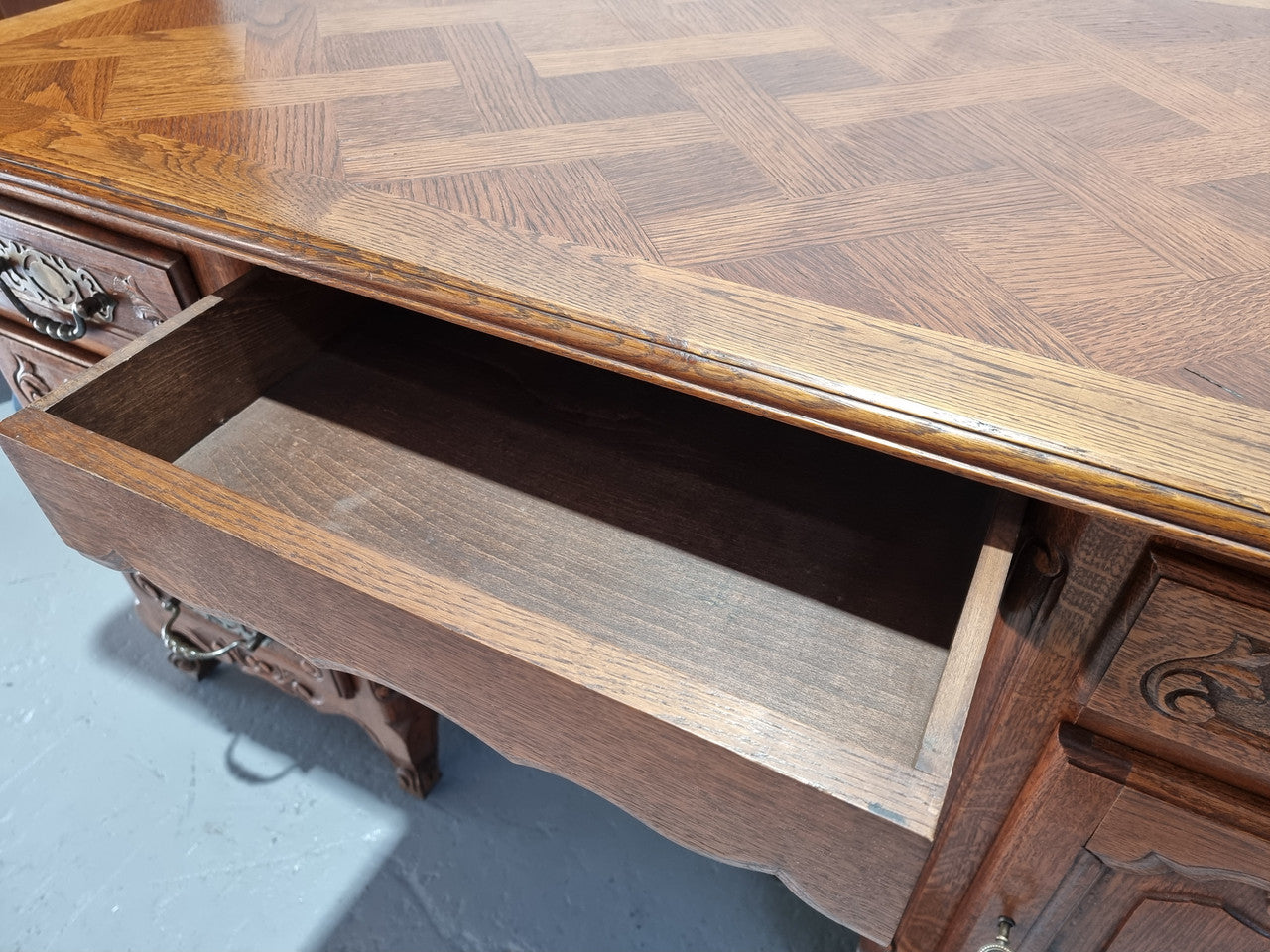 Beautifully carved french oak, faux partners desk with a lovely parquetry top and 6 drawers and 1 cupboard . In good original condition.