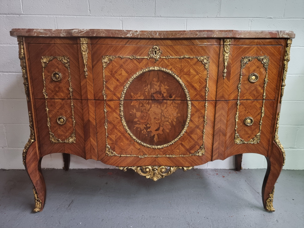Stunning Louis XV style ormolu and marquetry marble top commode with two drawers. It has an amazing thick marble top and it is in good original detailed condition.