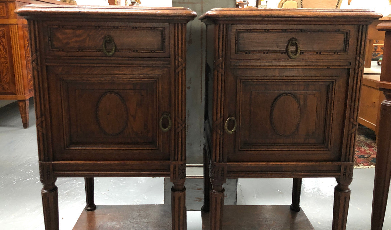 Lovely pair of French Oak Louis XVI style bedside cabinets with inset marble tops a drawer and a cupboard for storage. In good original detailed condition.