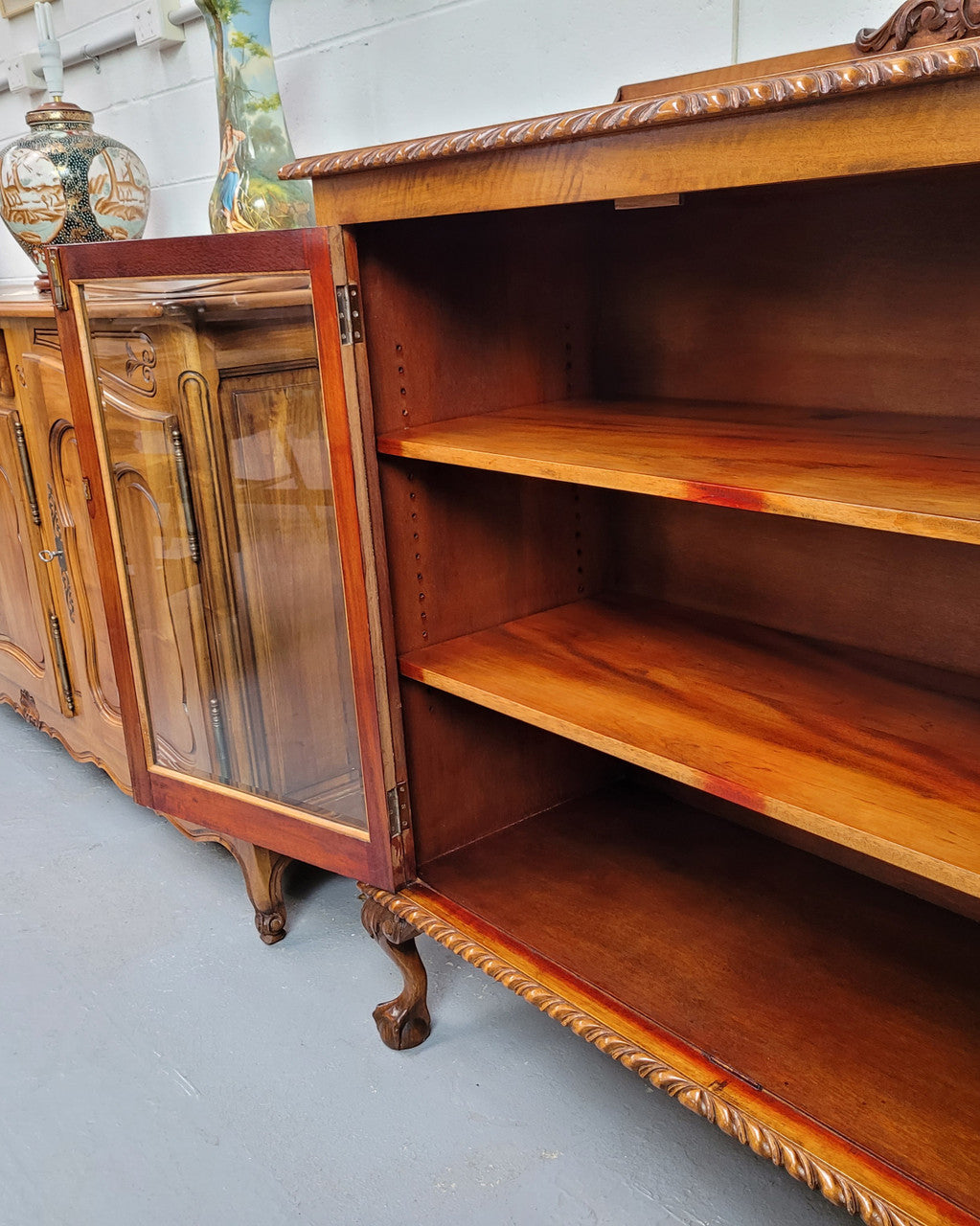 Chippendale style Mahogany two door bookcase. It has bevelled glass doors and two adjustable shelves. It has been sourced locally and is in good original detailed condition.