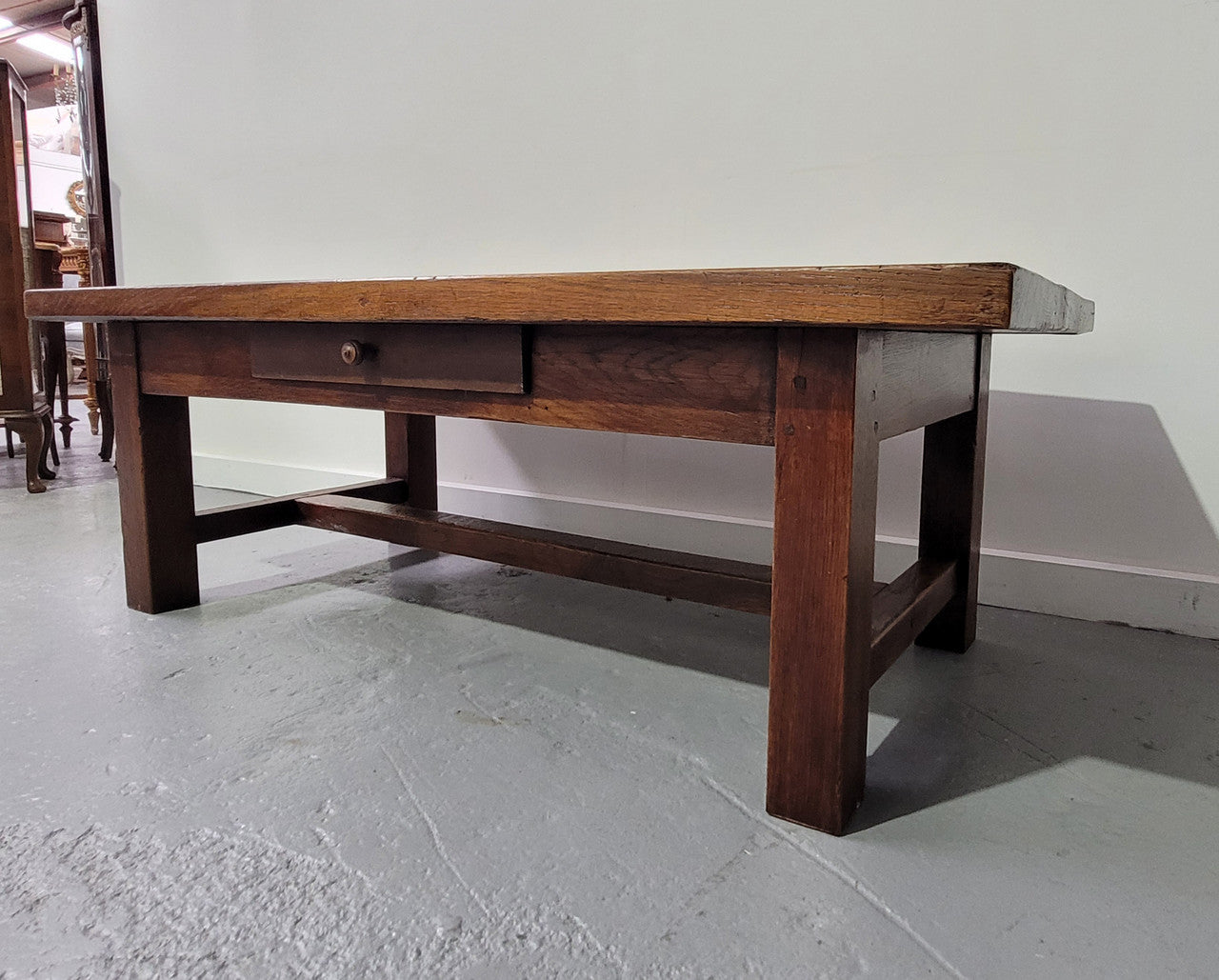 French Farmhouse style heavy Oak coffee table featuring a single drawer. In good original detailed condition.