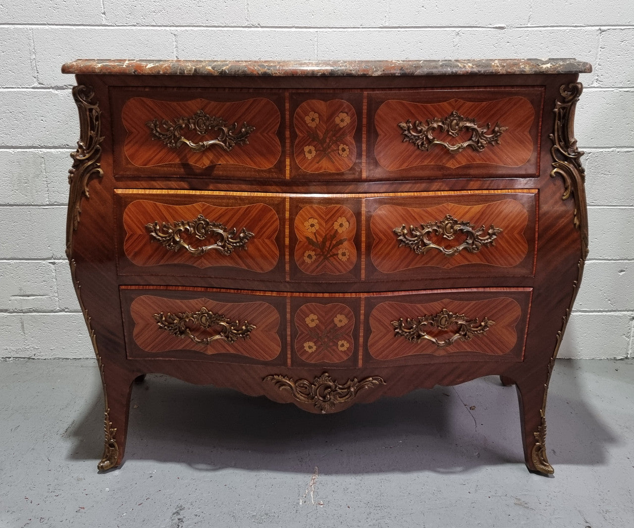 French Walnut and Kingwood Louis XV style marquetry inlaid commode with three drawers and a beautiful marble top. It is in good original detailed condition.