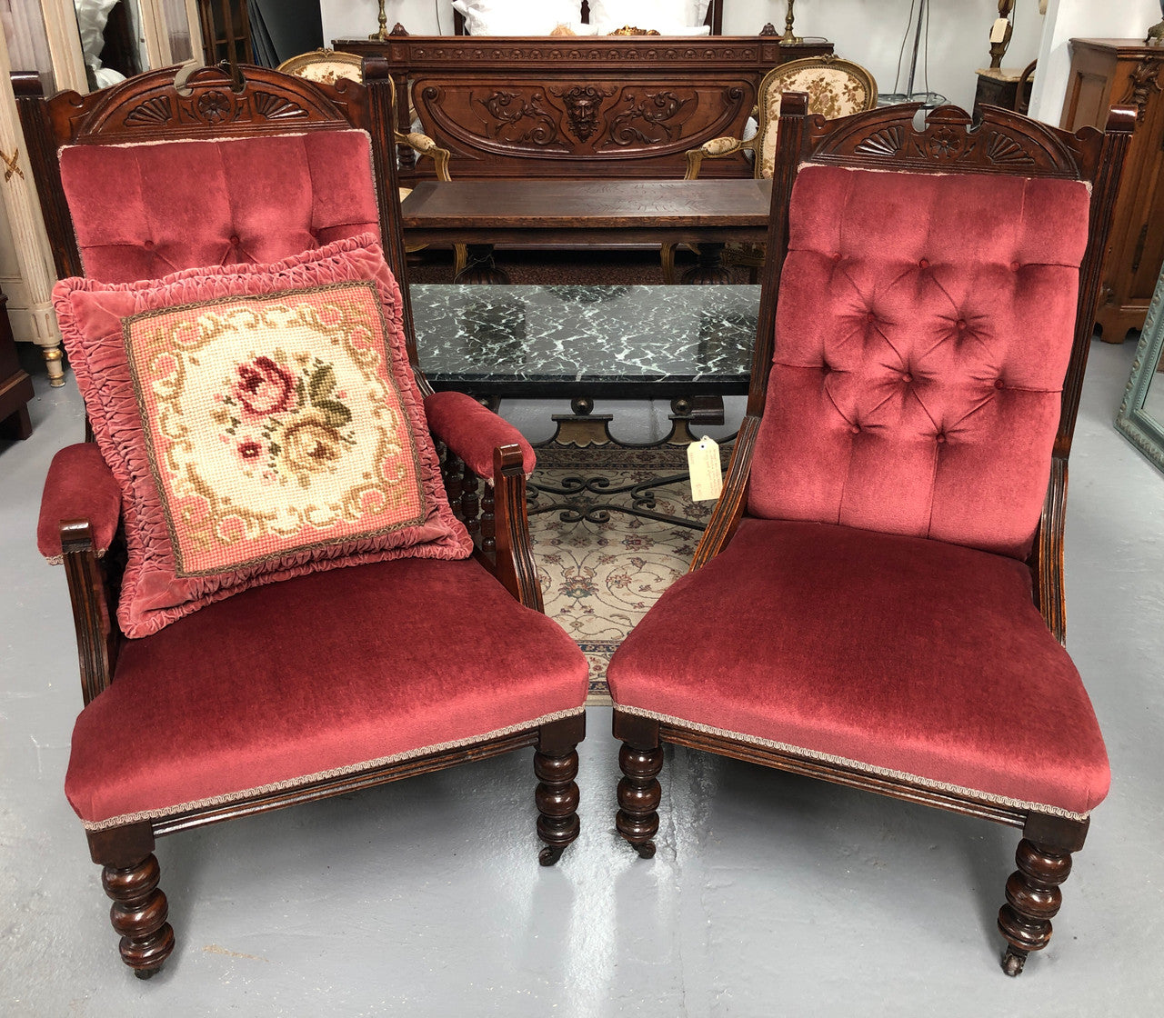 Beautiful pair of carved Edwardian arm chairs with lovely pink upholstery with button backs. In good condition.