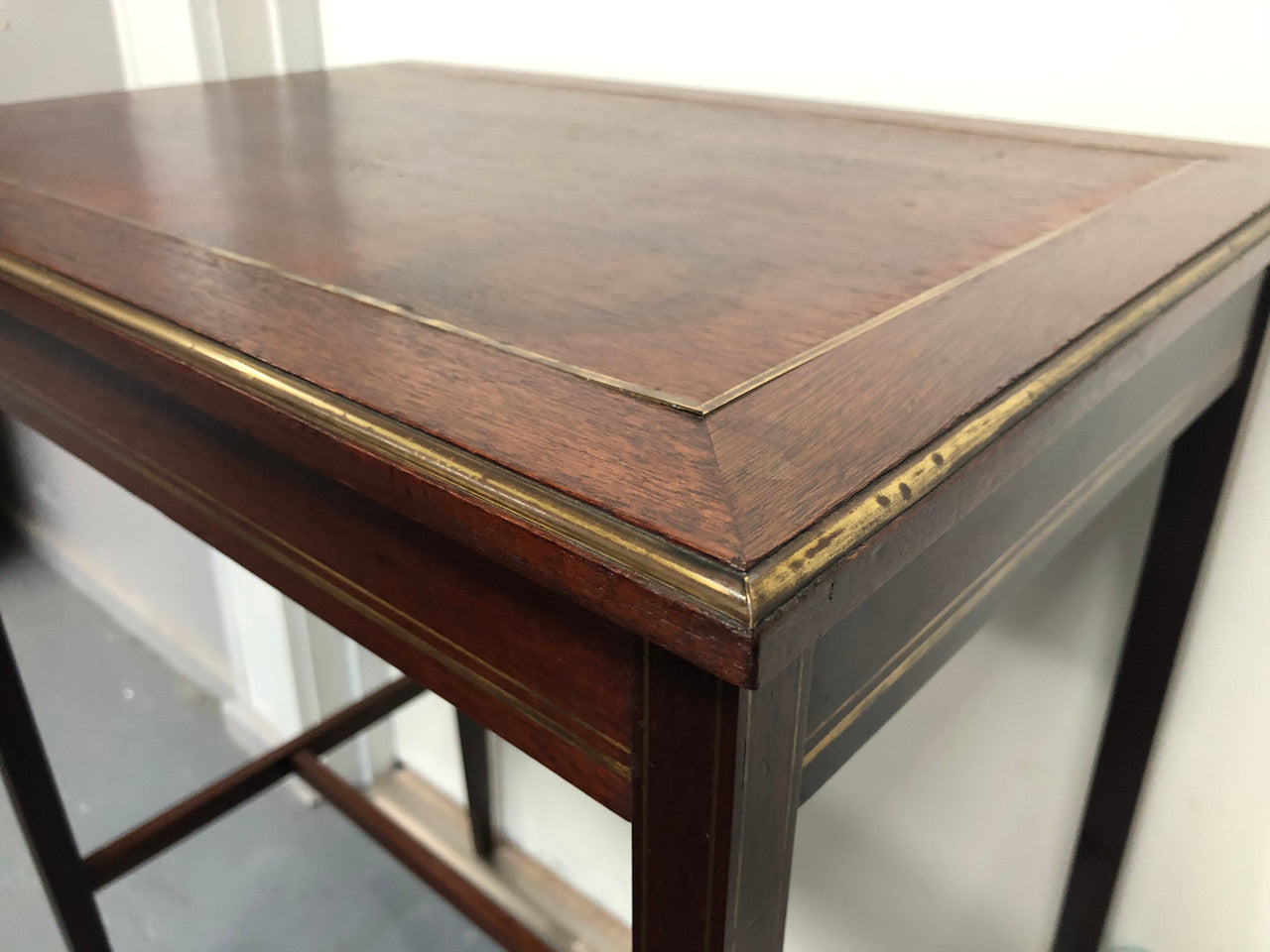 Elegant rectangular mahogany French brass inlaid occasional table. Is in good original condition.