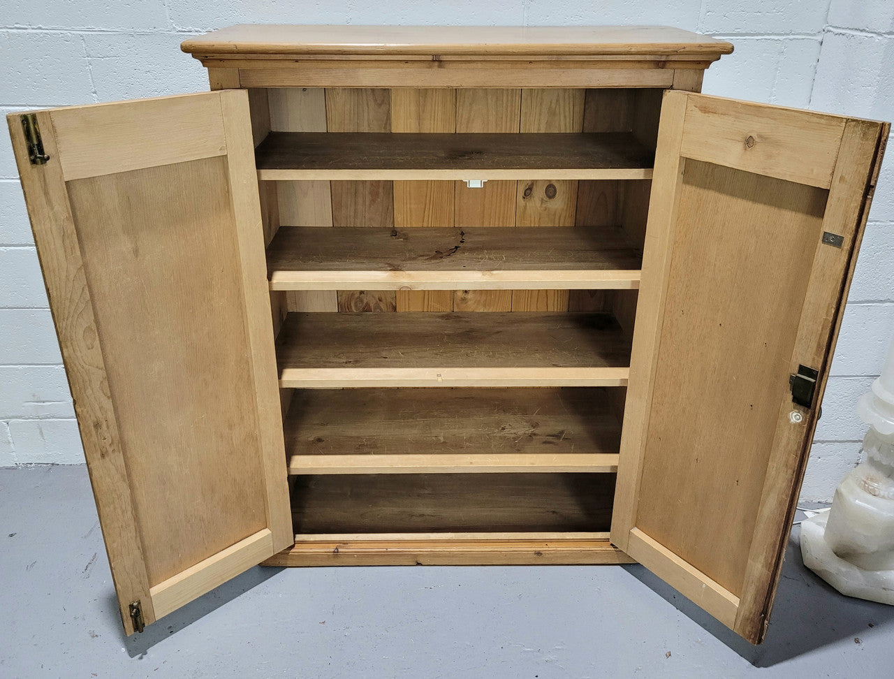 A lovely Victorian Pine shield cupboard with two doors and four shelves in good original detailed condition.