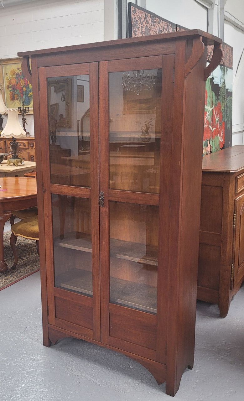 Beautiful two door Blackwood bookcase with glass doors and with four fully adjustable shelves. It is in good original detailed condition.