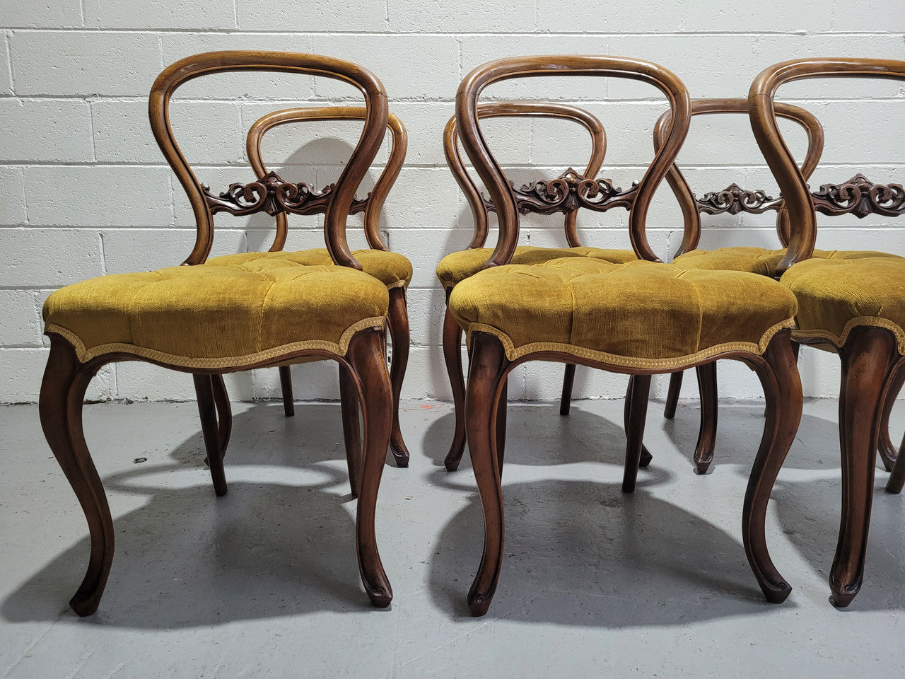 Set of six upholstered Victorian balloon back chairs. In good original detailed condition.