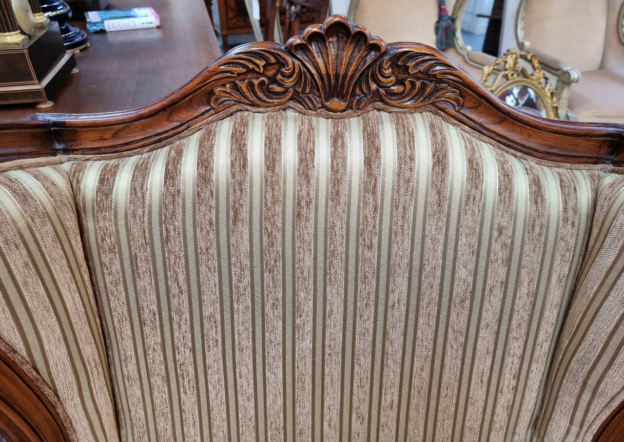 Beautiful pair of Walnut French-style newly upholstered wingback armchairs. They are in very good original detailed condition.