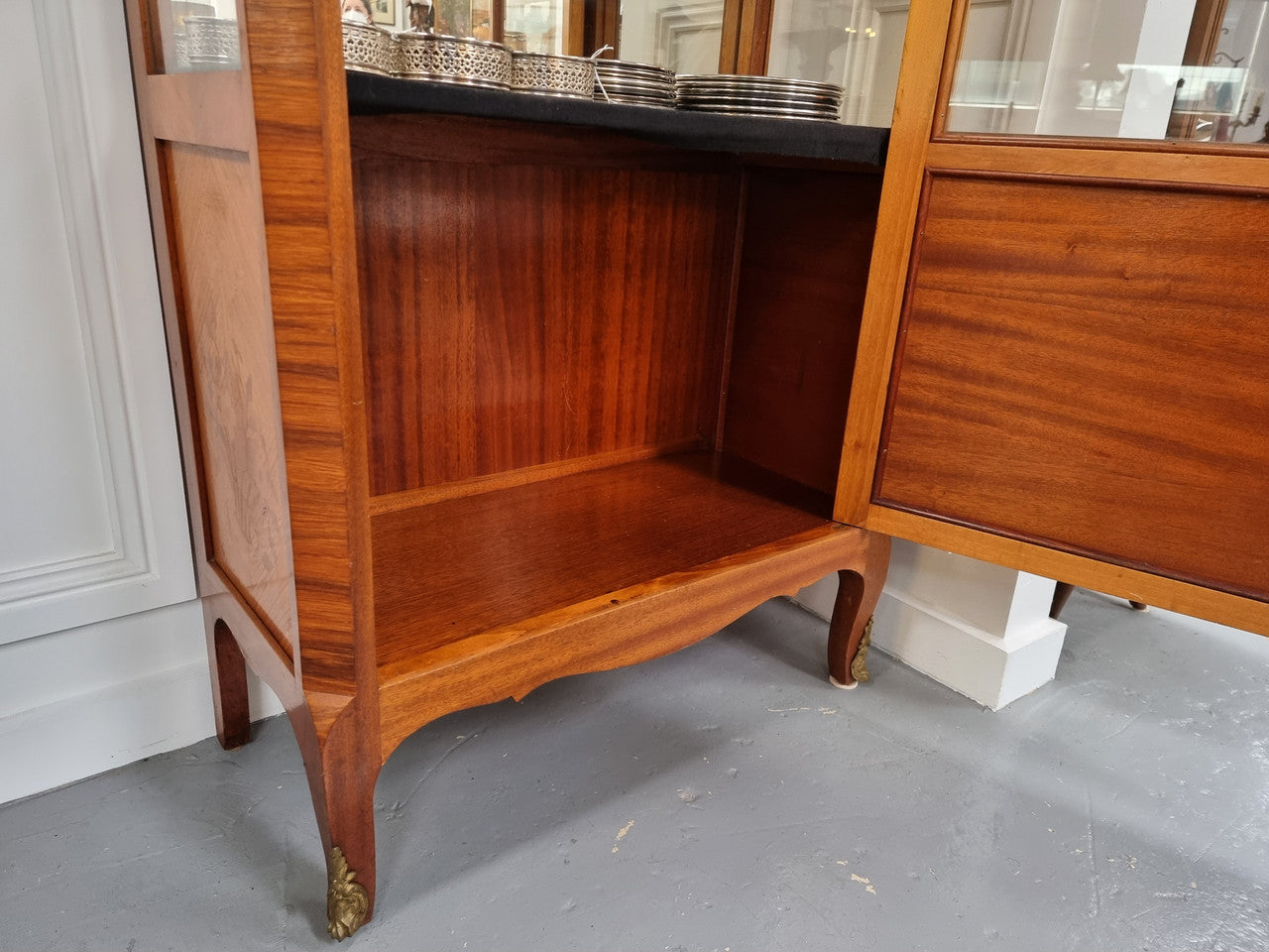 Beautiful French walnut inlaid vitrine with a lovely marquetry design and ormolu mounts. Has a beautiful coloured marble top and two glass shelves. In good original condition.