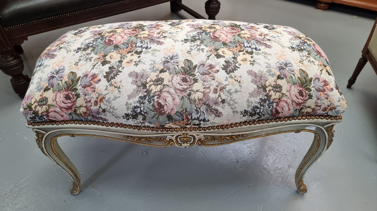Antique painted Louis XV style upholstered stool. It has lovely floral upholstery that is in good condition with no tears. It is in good original detailed condition.