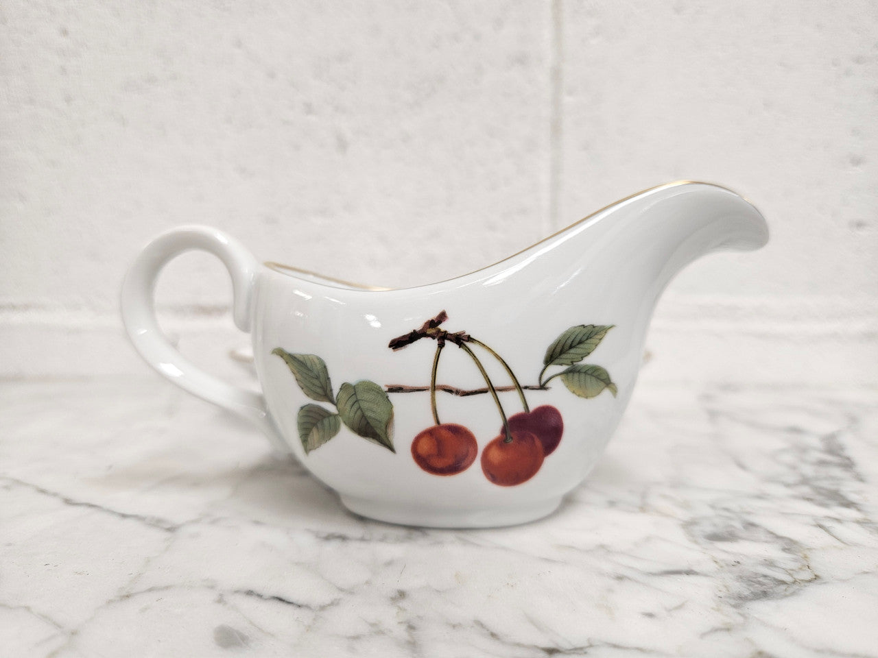 Royal Worcester "Evesham" Pattern small Jug and Saucer. Good Condition no cracks or chips. Please see photos as they form part of the description.