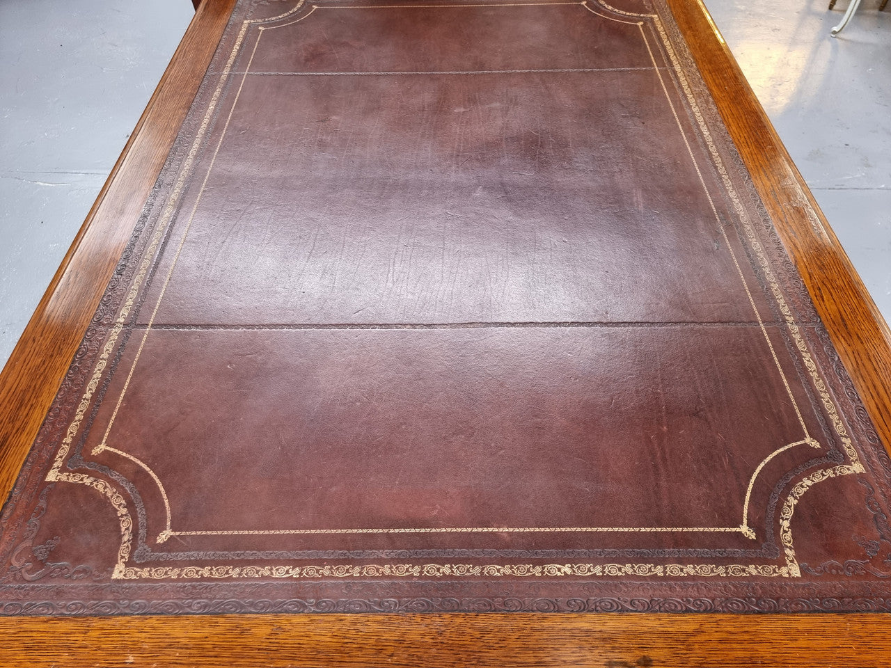 Substantial French Louis XVI style Oak partners desk. It has a beautiful leather top, two drawers on either side and decorative carvings throughout. Sourced from France and in good original detailed condition.