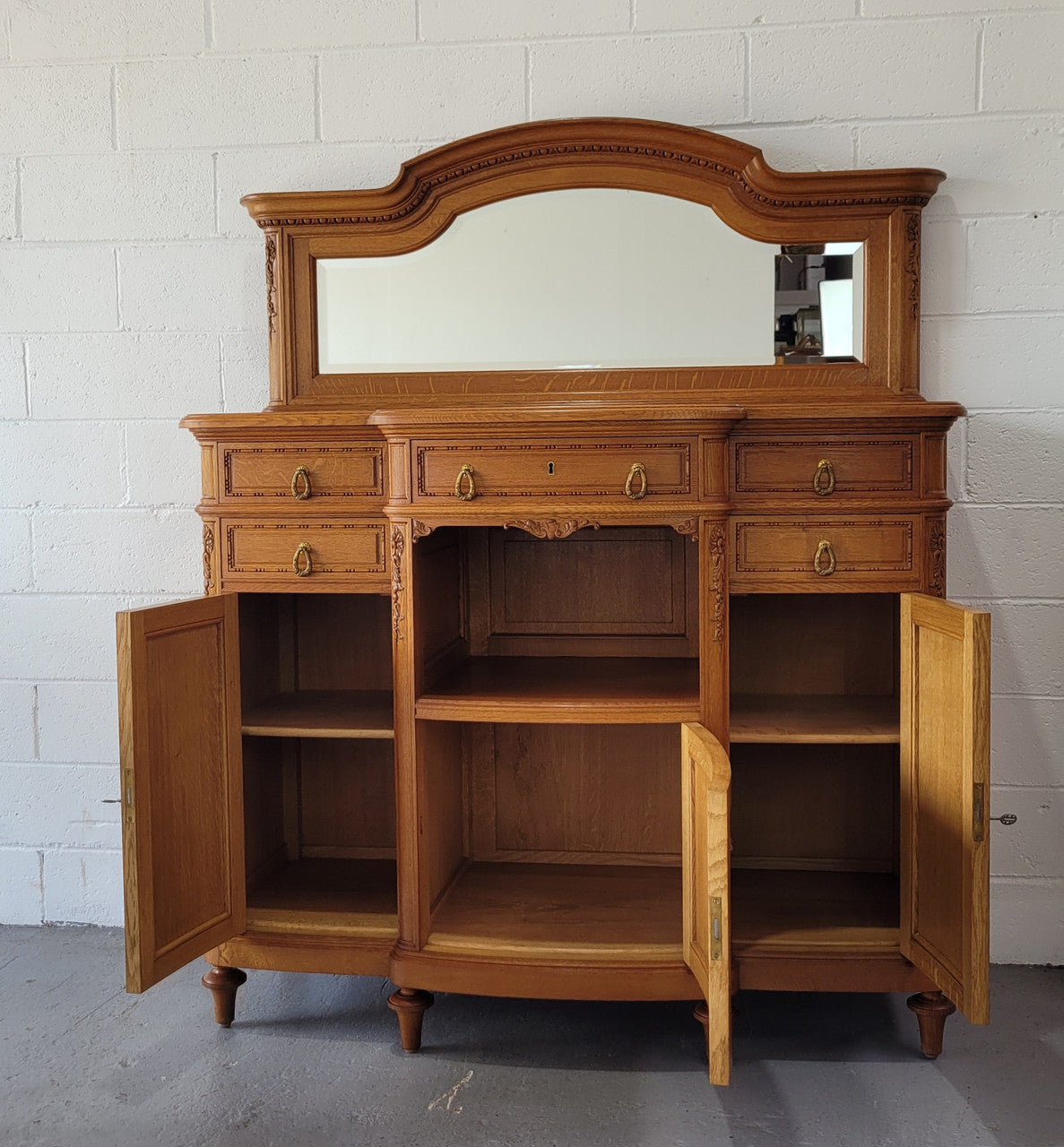 Beautiful French Oak Louis XVI Style nicely carved sideboard with a lovely parquetry top and mirror. It has five drawers and three cupboards for all your storage needs. In good original detailed condition.