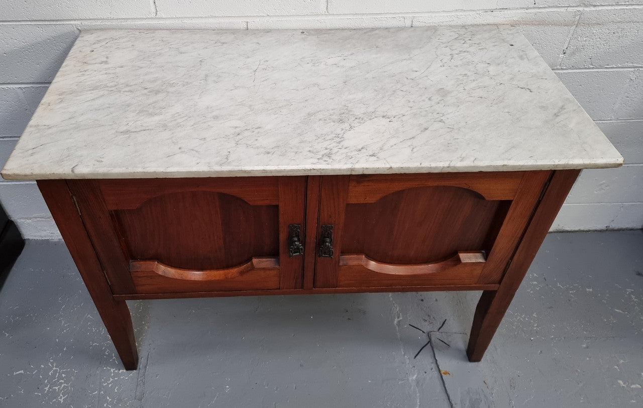 Blackwood two door white marble top cabinet. This would be ideal to be used as an entertainment unit, a TV stand or TV cabinet. In good original condition.