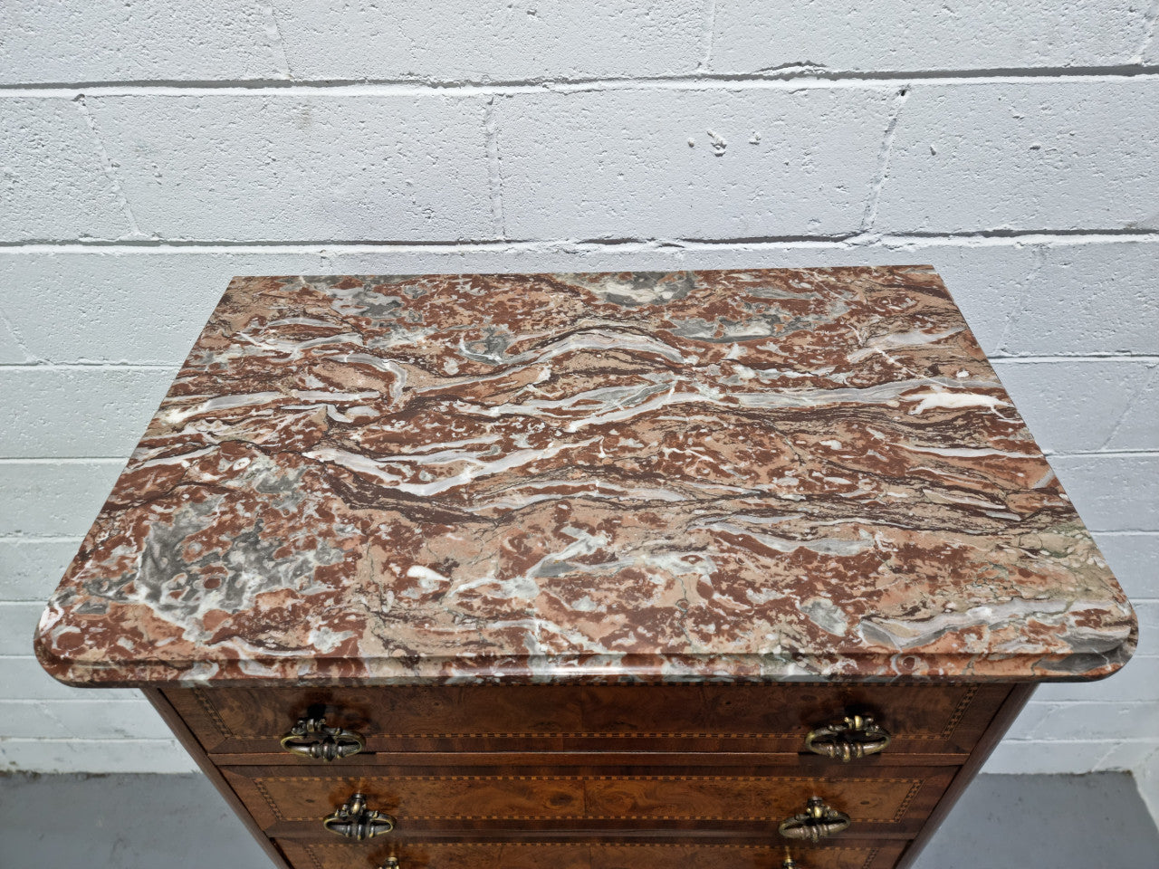 Louis XV style parquetry inlaid marble top semainier. It has seven drawers and a stunning coloured marble top. In good original condition.