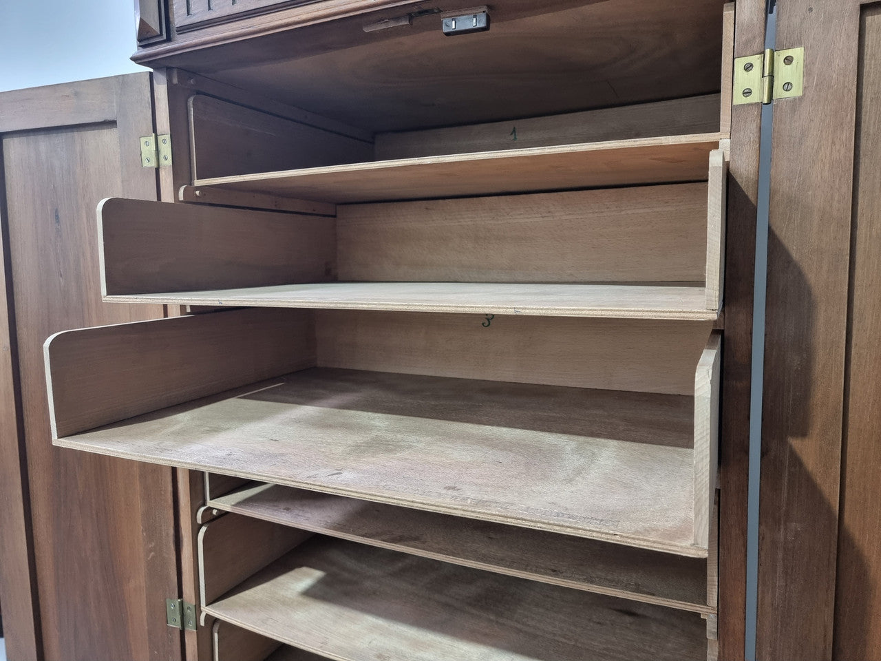 French Henry II style Walnut linen storage cupboard with nine pull out shelves. This piece could be very functional for a range of different purposes including shoe storage. It is in good original detailed condition, please note the door lock no longer functions and opens by pulling the door.