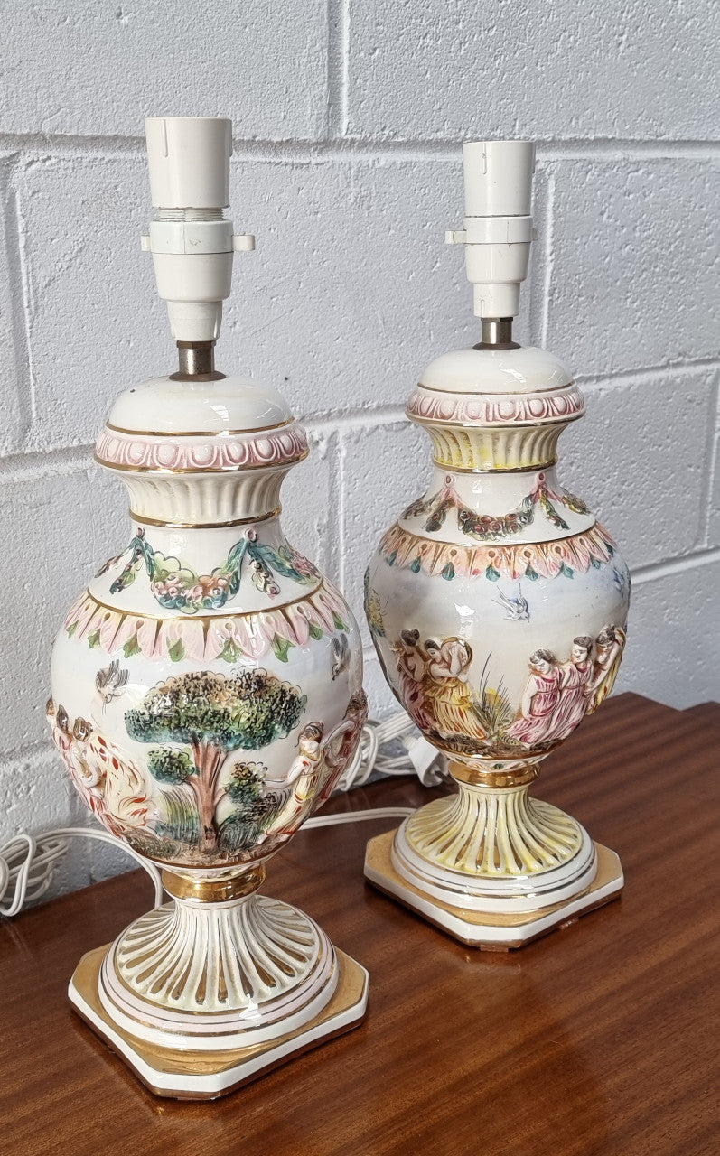 Pair of hand painted capodimonte vintage table lamps. In good original detailed working condition.