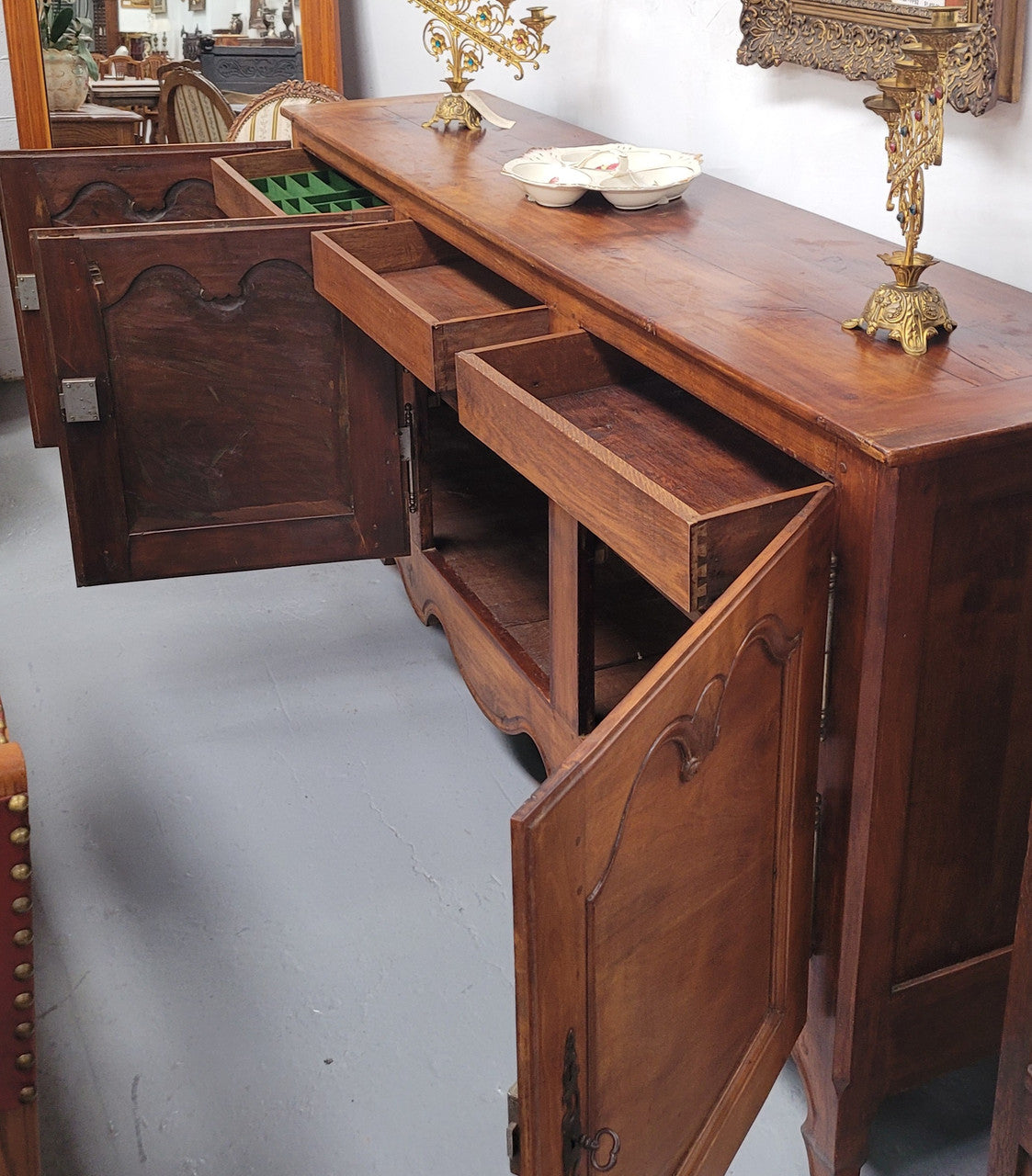 Early 19th Century Louis XV style Fruitwood three door sideboard. It has three hidden internal drawers and one of them has green valet and small sections for cutlery. It is in good restored condition.