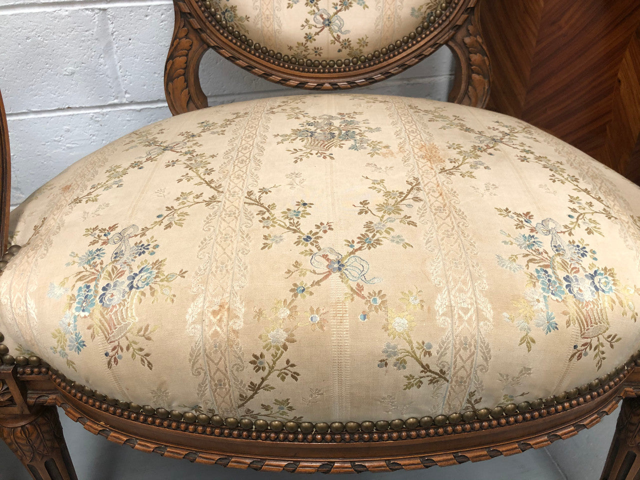 Pair of Antique French Louis XVI style carved Walnut fauteuils in restored condition. The Tapestry upholstery is in good condition some marks and wear but usable.