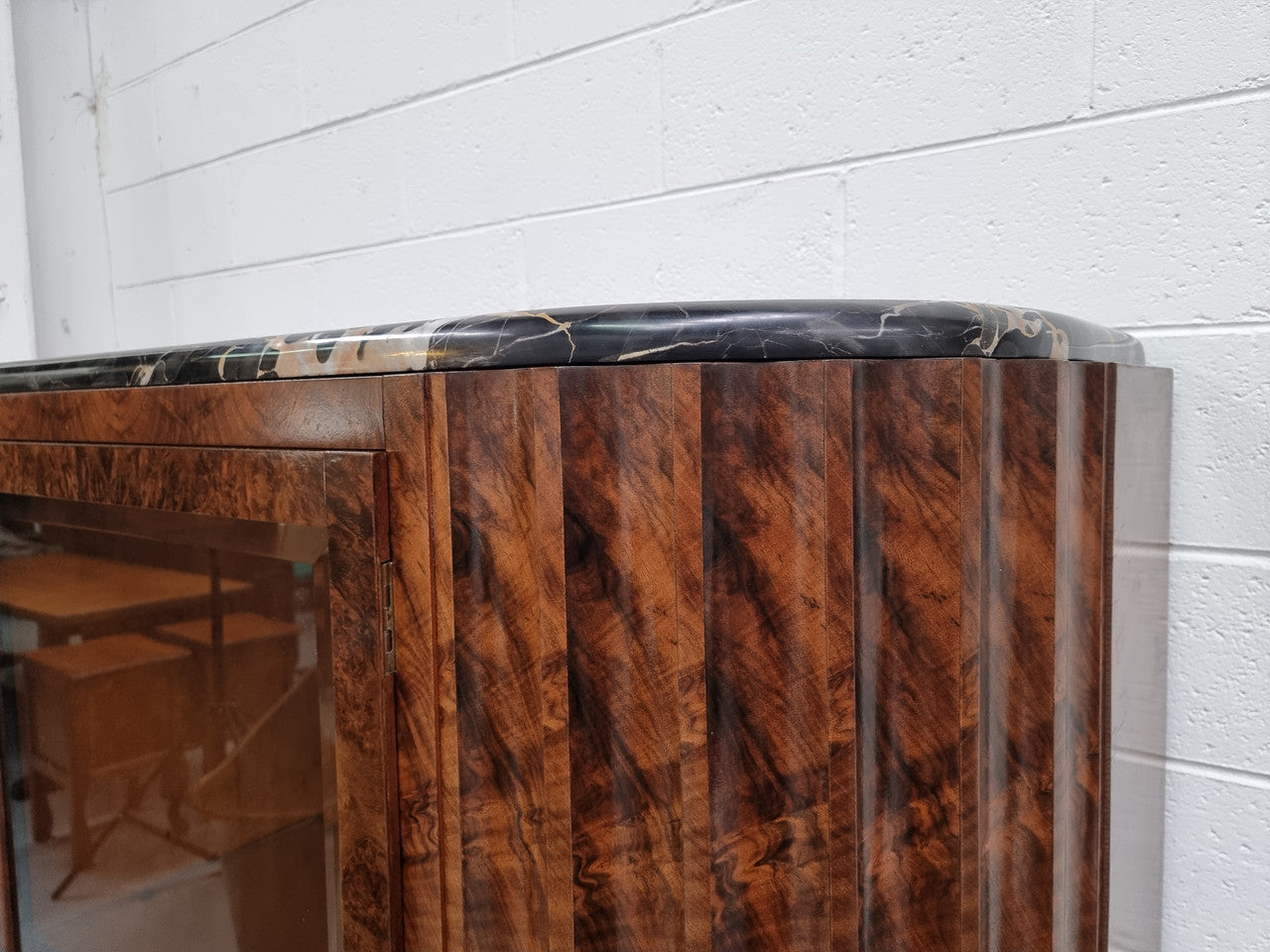 Stunning French Art Deco figured Walnut with Portoro marble top cocktail cabinet. Features chrome trim on base and glass display in door. It is in fully restored condition.