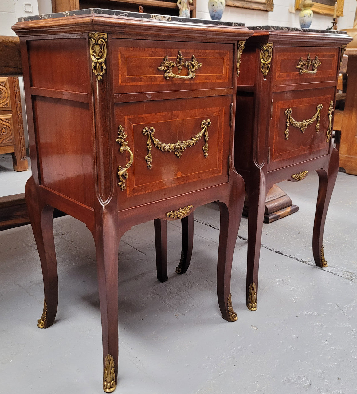 Appealing Louis XV style high quality bedside cabinets with black Portoro marble top and bronze mounts. They have been sourced from France and are in good original condition.