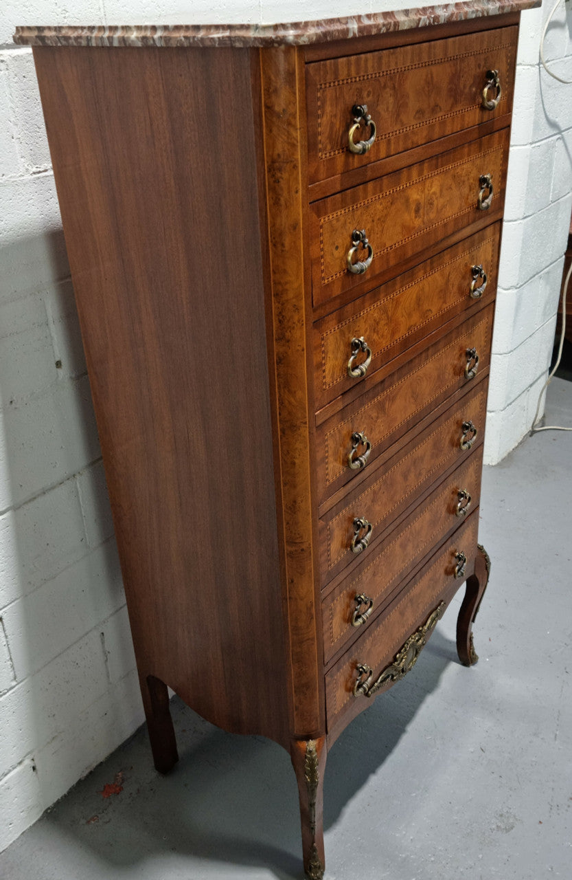 Louis XV style parquetry inlaid marble top semainier. It has seven drawers and a stunning coloured marble top. In good original condition.