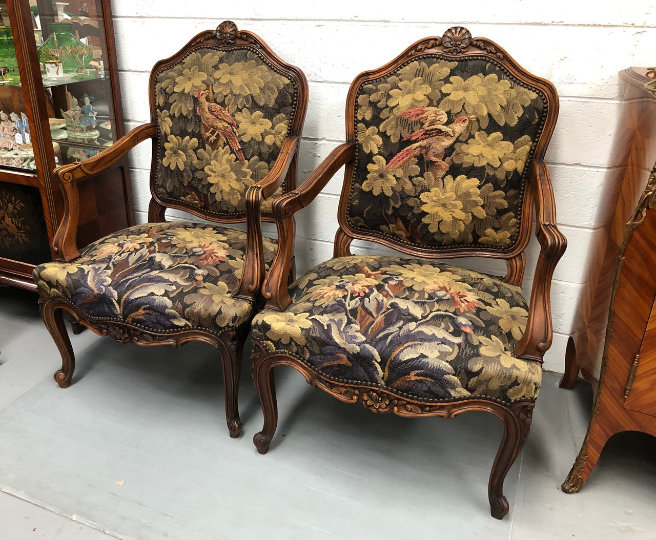 Pair of 19th Century French walnut tapestry covered arm chairs. They are in good original condition. Circa 1890.