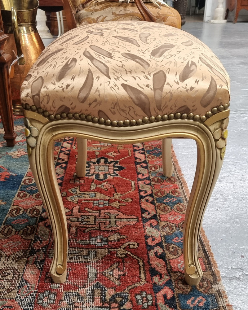 Appealing French Louis 15th style hand painted and gilded stool with good upholstery. In good original detailed condition.