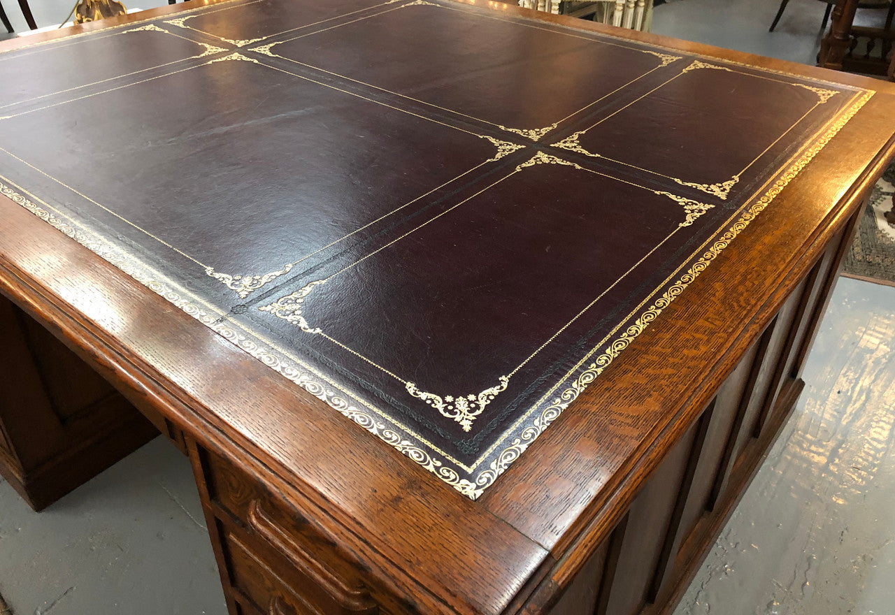 Lovely large English oak partners desk, with a beautiful burgundy tooled leather top. Plenty of storage space, both sides have 9 functioning drawers. It is in very good condition.