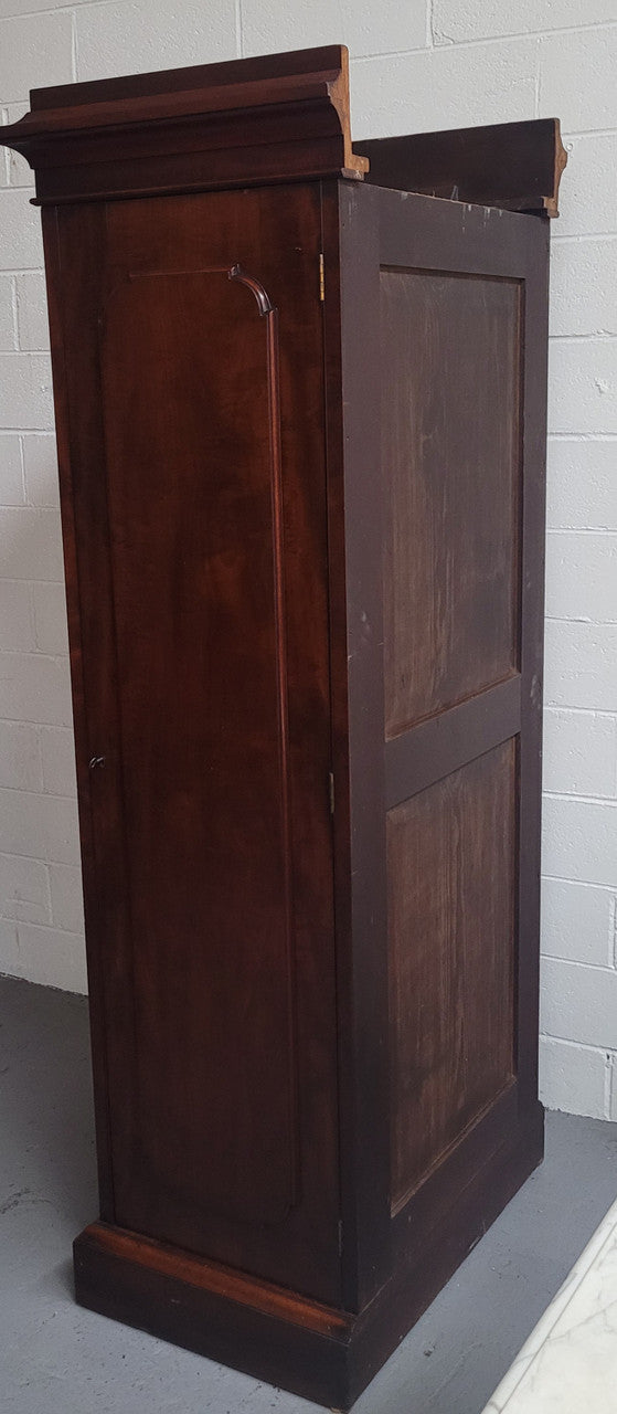 Unusual Victorian Flame Mahogany side wardrobe with side door. It has full hanging and six hooks. The wardrobe opens from a side door which can be locked with its key and has a markers mark stamp on the door. It is in good original condition.