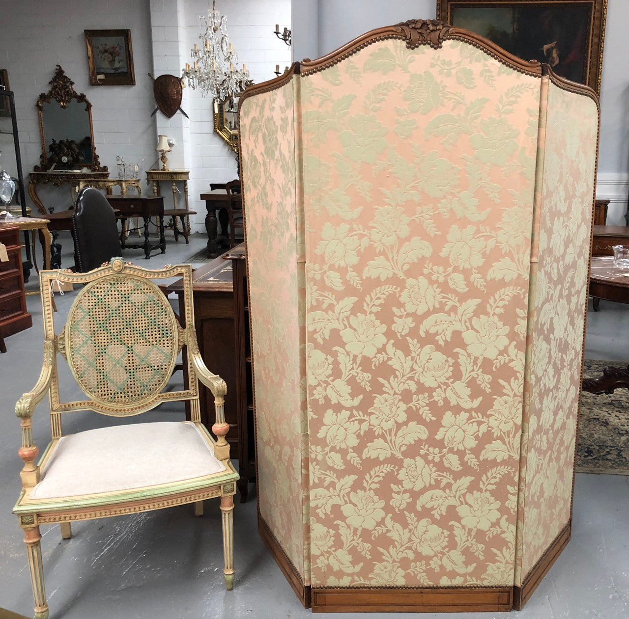 An antique French Walnut louis XVI style 3 fold screen/divider. Upholstered with beautiful pink silk brocade fabric. The fabric is in good overall condition with some minor wear and tear which is expected for its age. It has been sourced directly from France. Please view photos as they help to form part of the description and condition.
