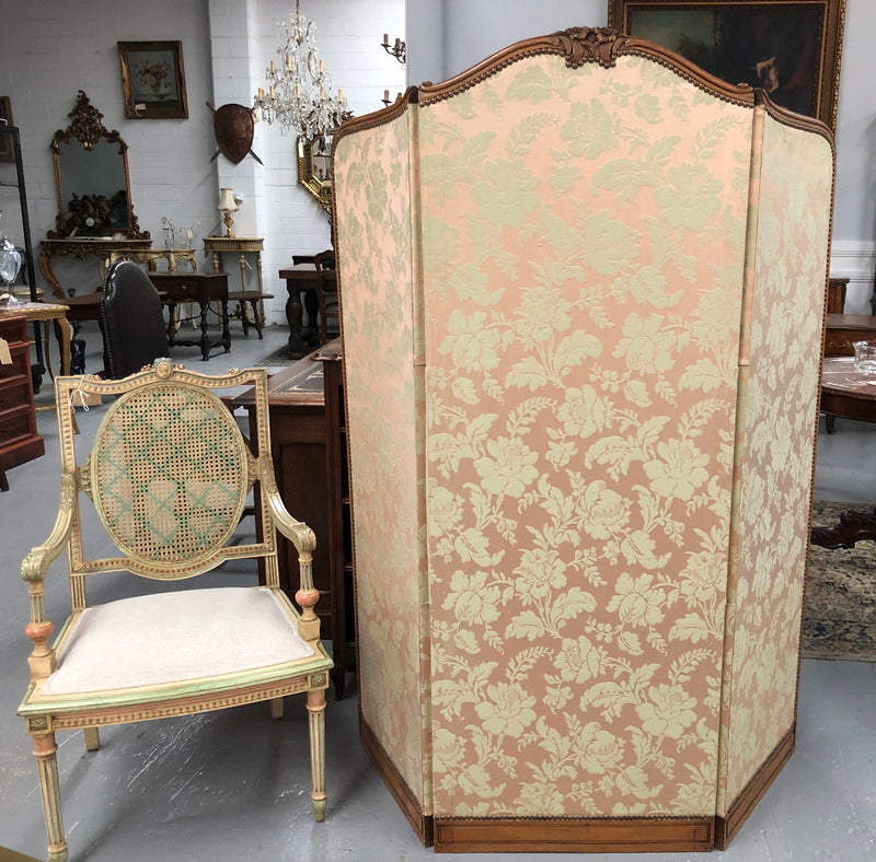 An antique French Walnut louis XVI style 3 fold screen/divider. Upholstered with beautiful pink silk brocade fabric. The fabric is in good overall condition with some minor wear and tear which is expected for its age. It has been sourced directly from France. Please view photos as they help to form part of the description and condition.
