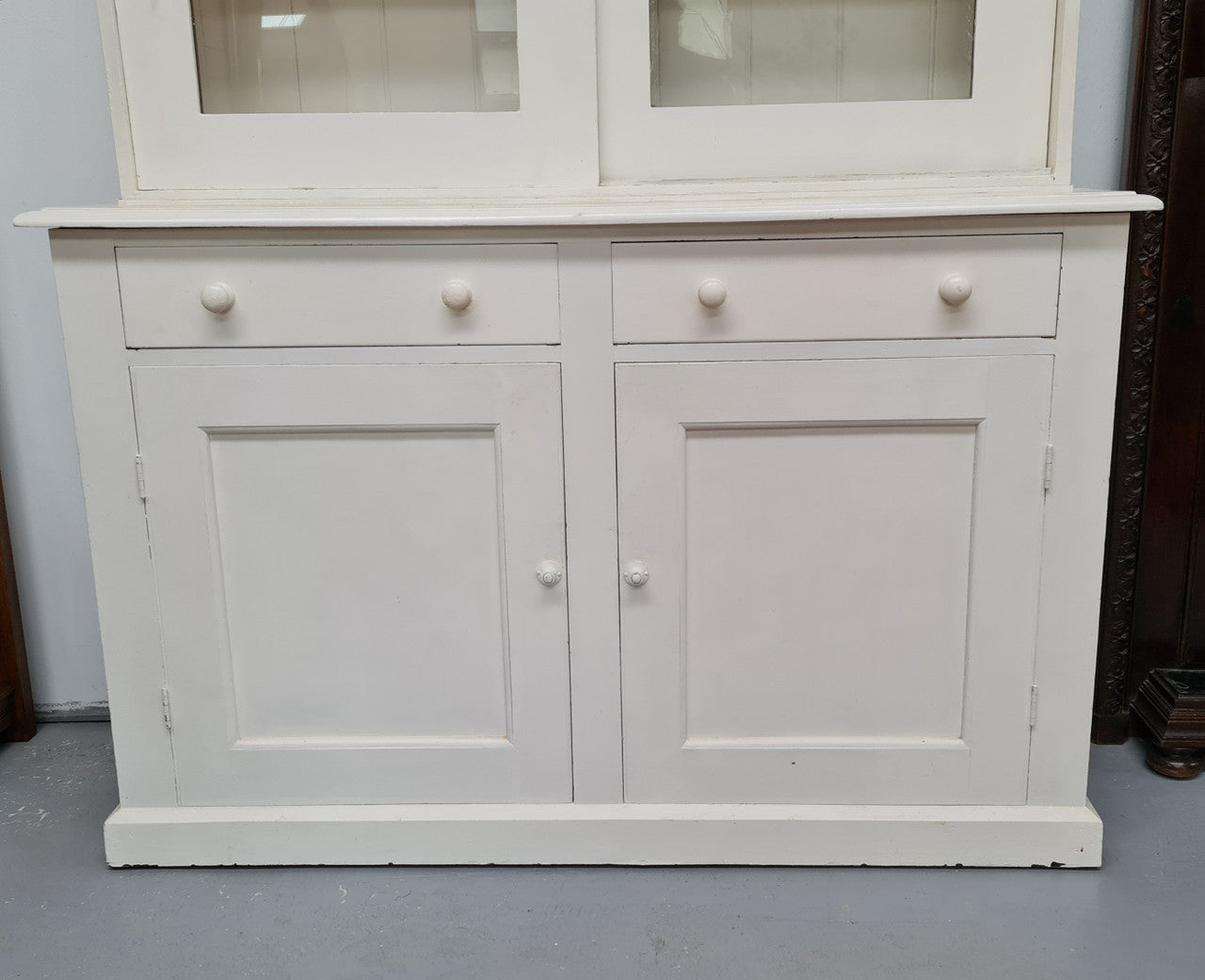 Australian painted two door kitchen hutch display and buffet cabinet. The top section has hooks and shelves. The bottom has two drawers along with cupboard space for added storage. In good original condition.