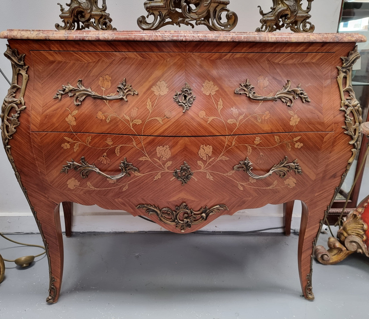 Stunning Louis XV style marquetry inlay marble top two drawer commode. It has decorative ormolu mounts and beautiful marble top. In good original detailed condition.