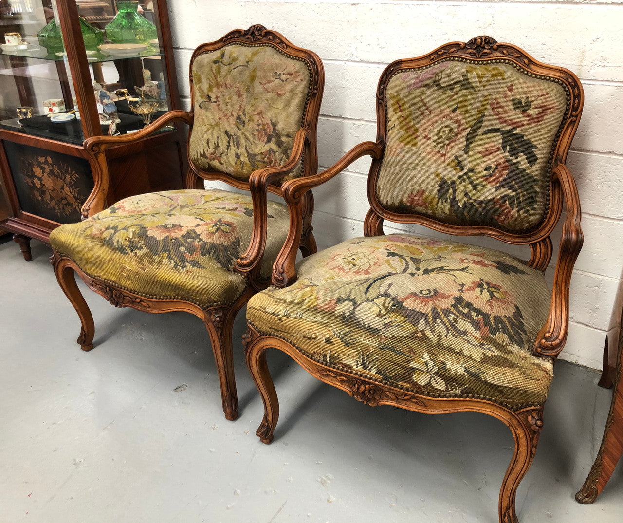 Pair of French Walnut Tapestry covered armchairs. They are in good original detailed condition. Slight wear and tear to fabric but still in good condition please view photos.