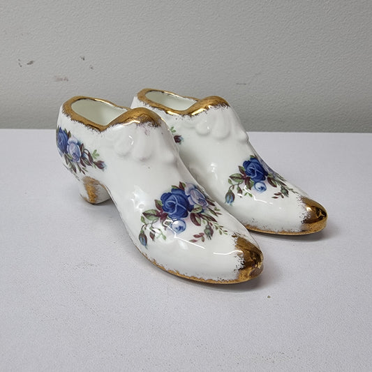 A lovely pair of Royal Albert China shoes in good original condition. Stamped on the sole 'Moonlight Rose: Royal Albert Bone China, England ©1987.