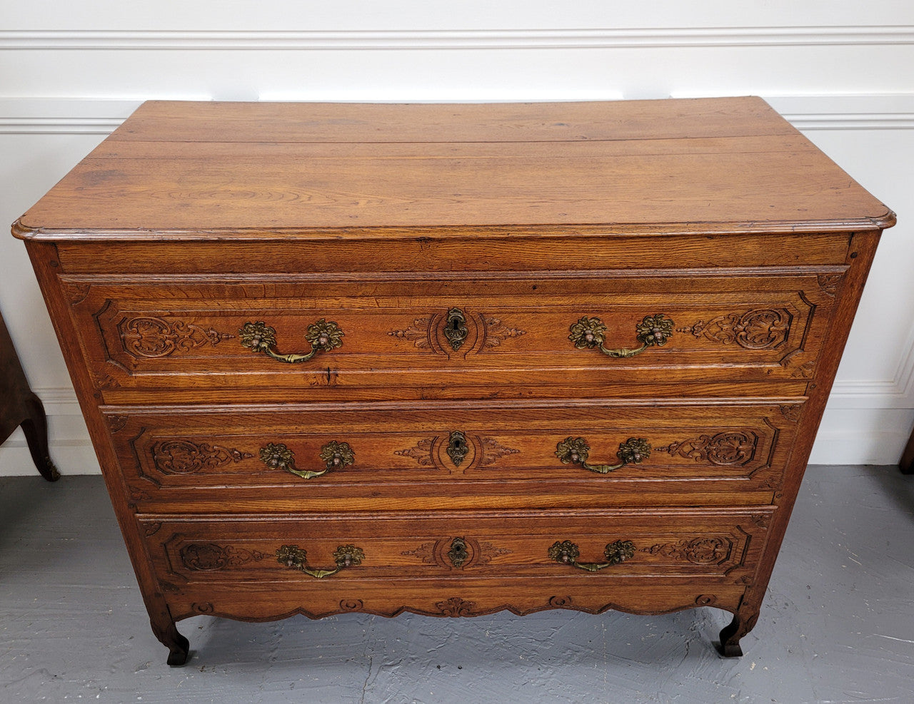 French Louis 15th style large three drawer chest featuring carved drawers. It has been sourced from France and is in good original detailed condition.