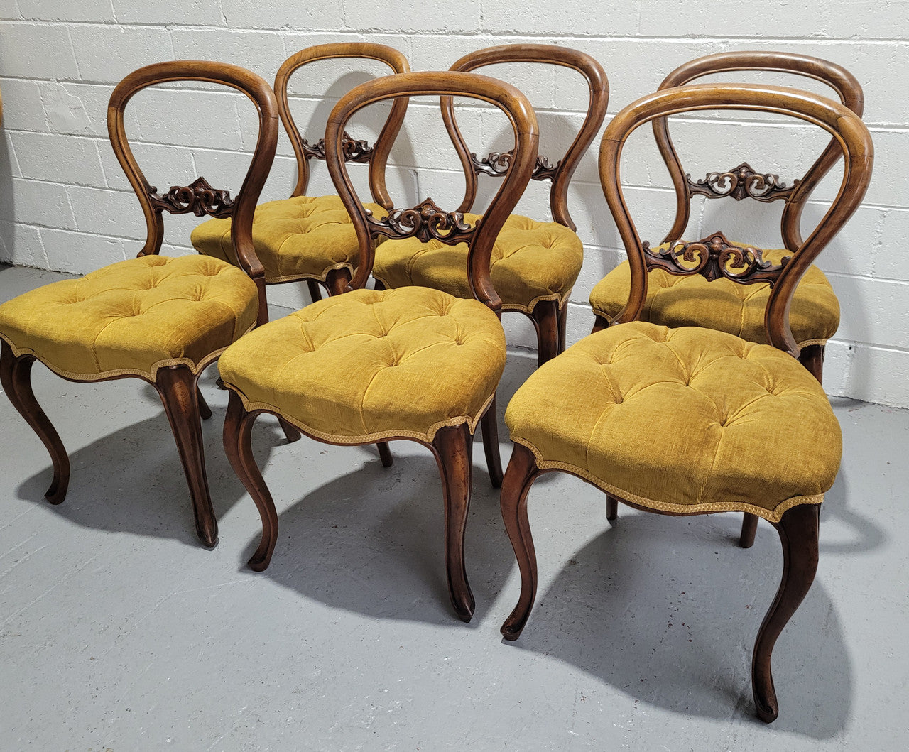 Set of six upholstered Victorian balloon back chairs. In good original detailed condition.