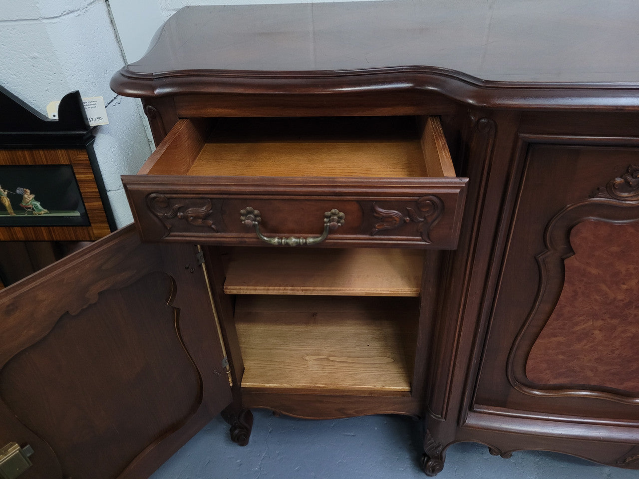 Fabulous Louis XV style French Walnut and Burr Walnut four door sideboard. Each door panel has beautiful Burr Walnut panels and open up to an adjustable shelf. Beautiful handles and two drawers for added storage. In good original detailed condition.