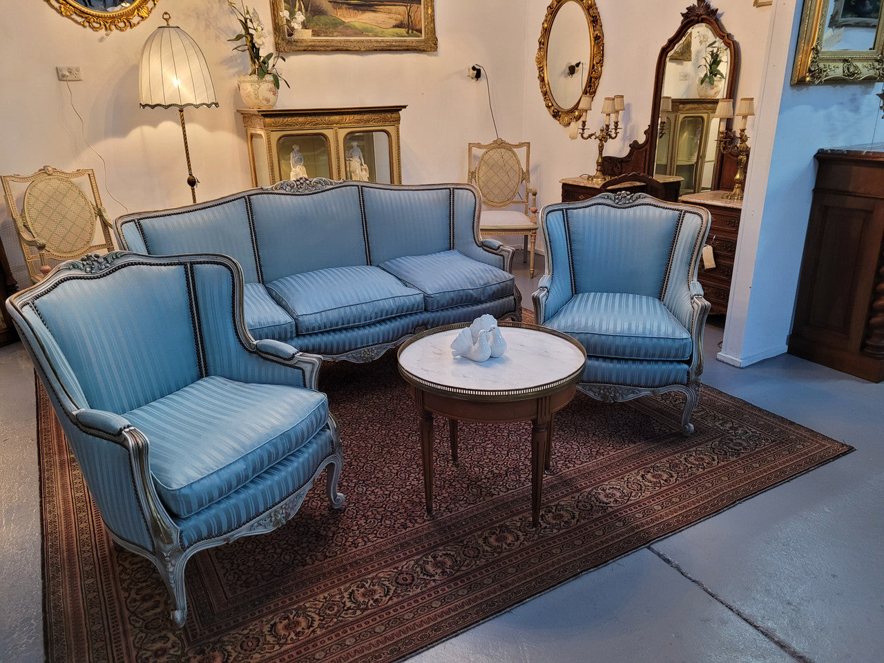 Well Proportioned Louis XV Salon Suite consisting of well proportioned 3 seater down cushioned, winged settee with 2 matching bergere chairs. All upholstered in stunning blue self stripe fabric. In excellent condition. Circa: 1930's.