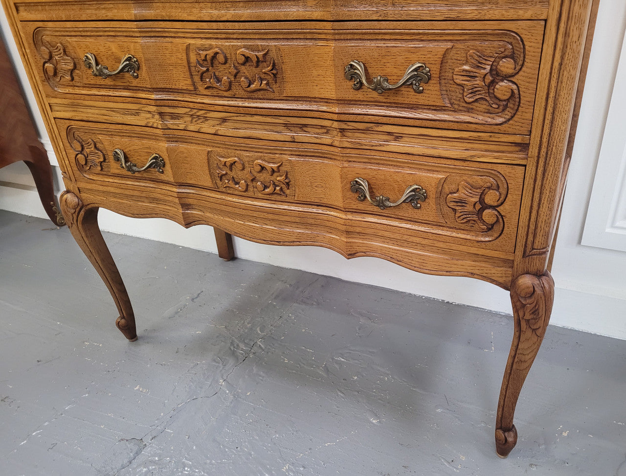 French Oak Louis 15th style nicely carved three drawer wooden top commode. It has been sourced from France and is in good original detailed condition.