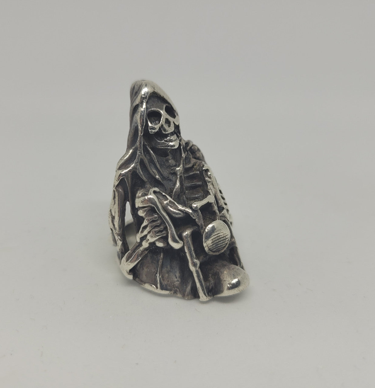 Heavy sterling silver biker ring. Hand caste skeleton on bike. Marked 925. In good condition.