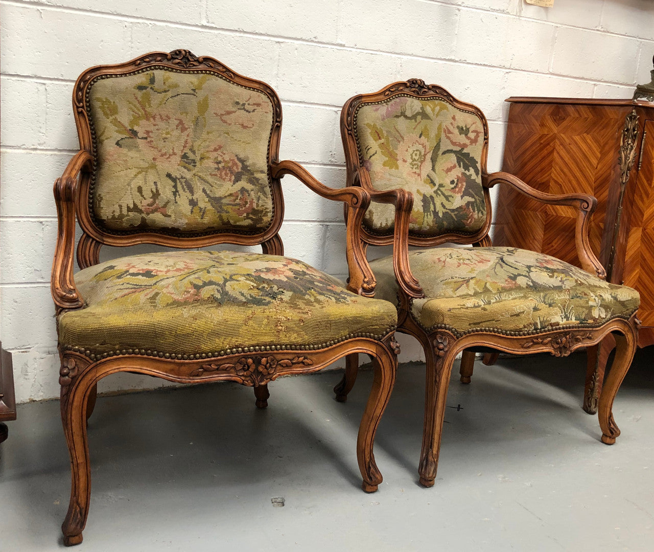 Pair of French Walnut Tapestry covered armchairs. They are in good original detailed condition. Slight wear and tear to fabric but still in good condition please view photos.