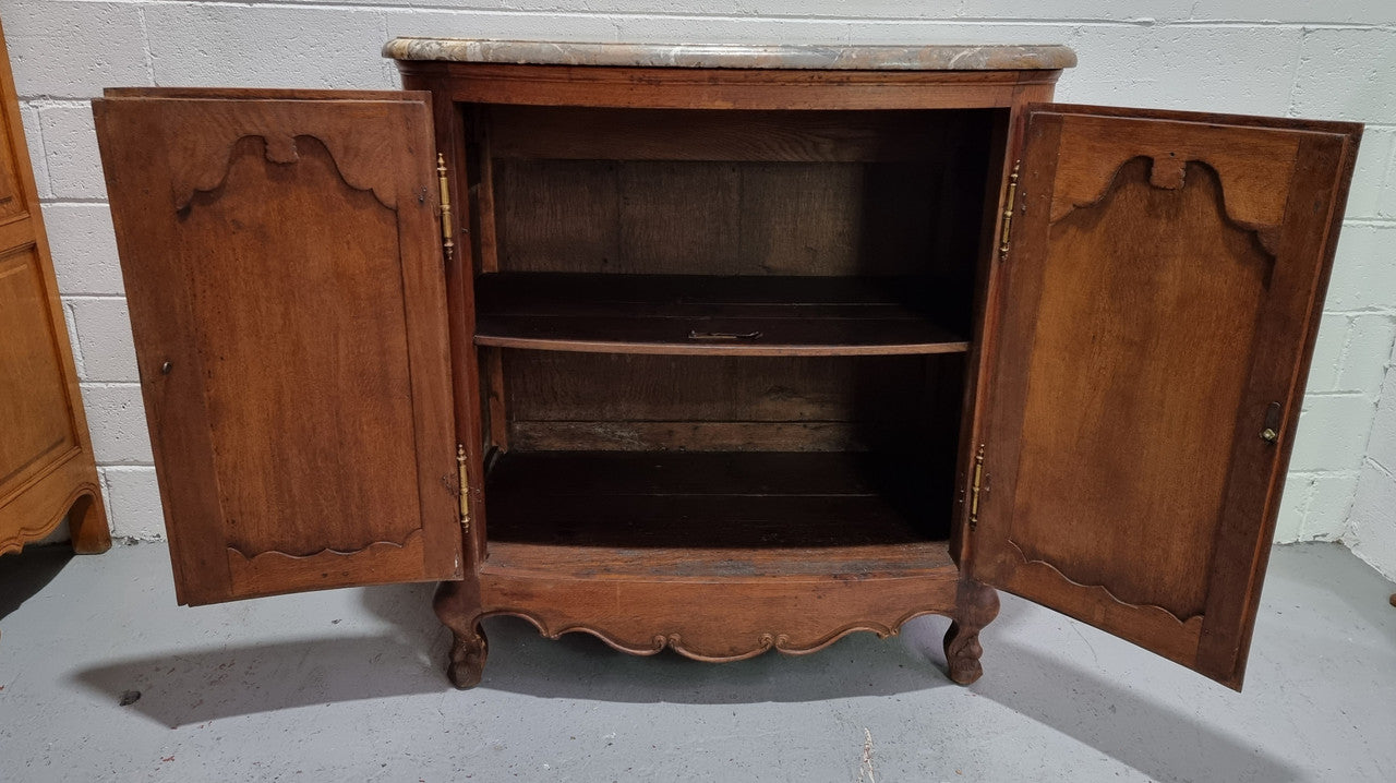 Rare 19th Century French Oak and marble top oval buffet / cabinet. Stunning thick marble top and decorative handles. In good original detailed condition.