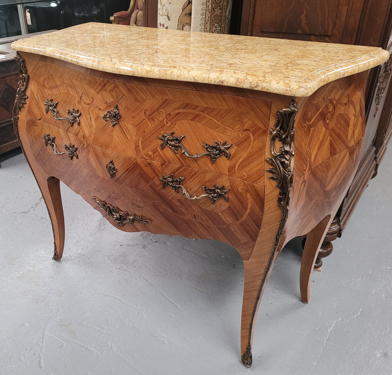 An elegant French Louis XV style kingwood two drawer commode with beautiful decorative inlay and ormolu mounts. Stunning coloured marble top and is in good original detailed condition.