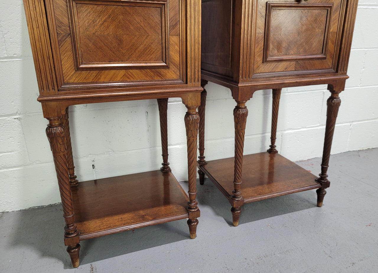 Pair parquetry Walnut bedside cabinets with white inset marble tops. In good original detailed condition.