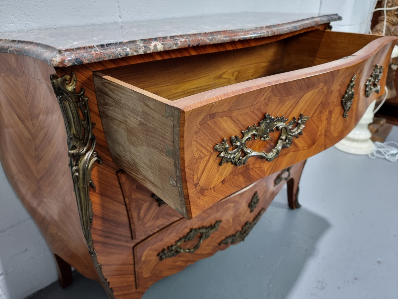 Attractive French marble top Louis XV style three drawer commode with decorative ormolu mounts. In good original detailed condition.