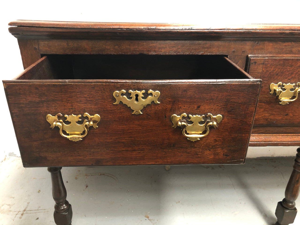 Early 19th Century English Oak dresser base with three large drawers. In very good original detailed condition.