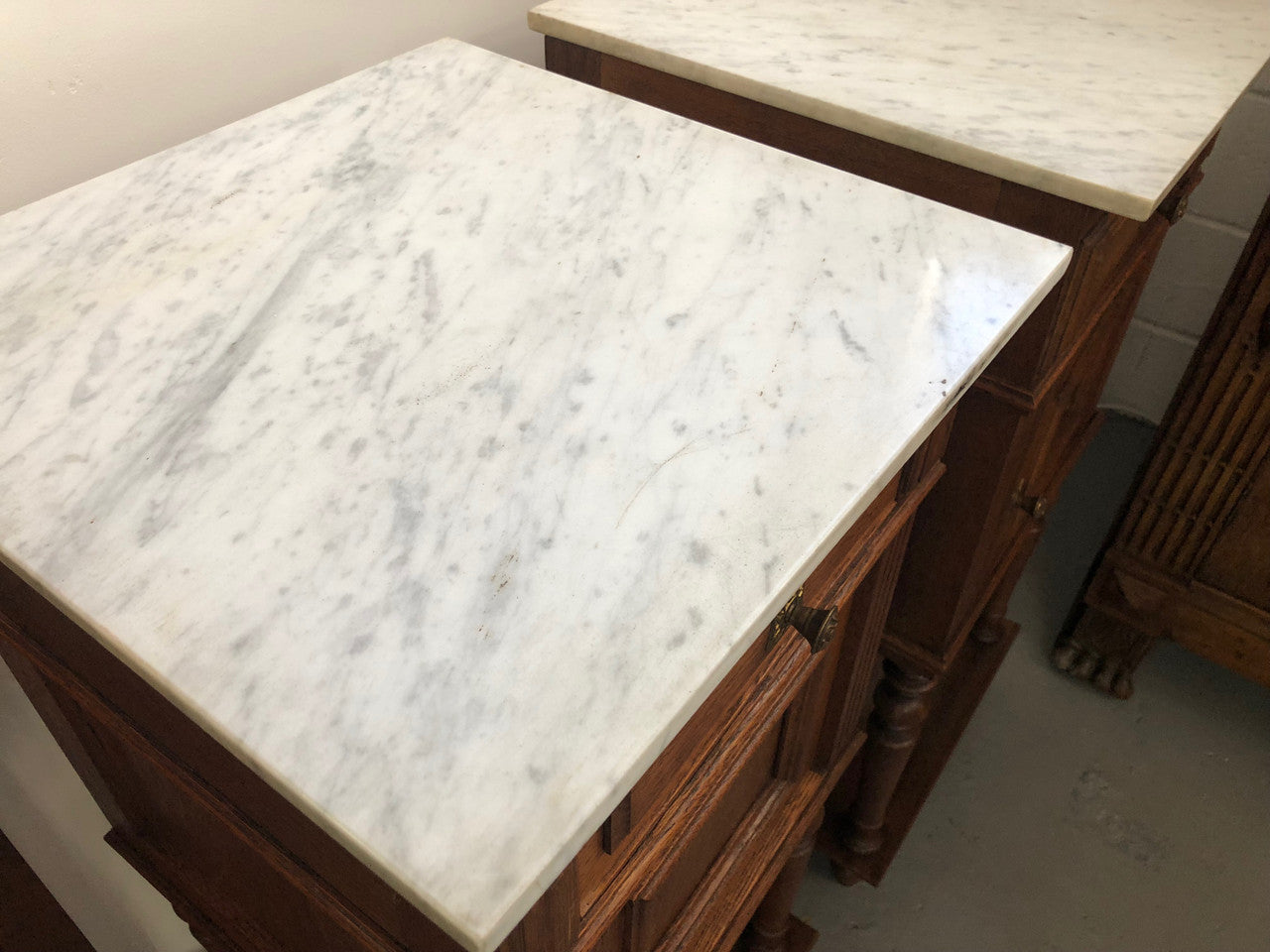 A lovely pair of French Oak, marble top bedside cabinets with a cupboard and drawer in good original condition.
