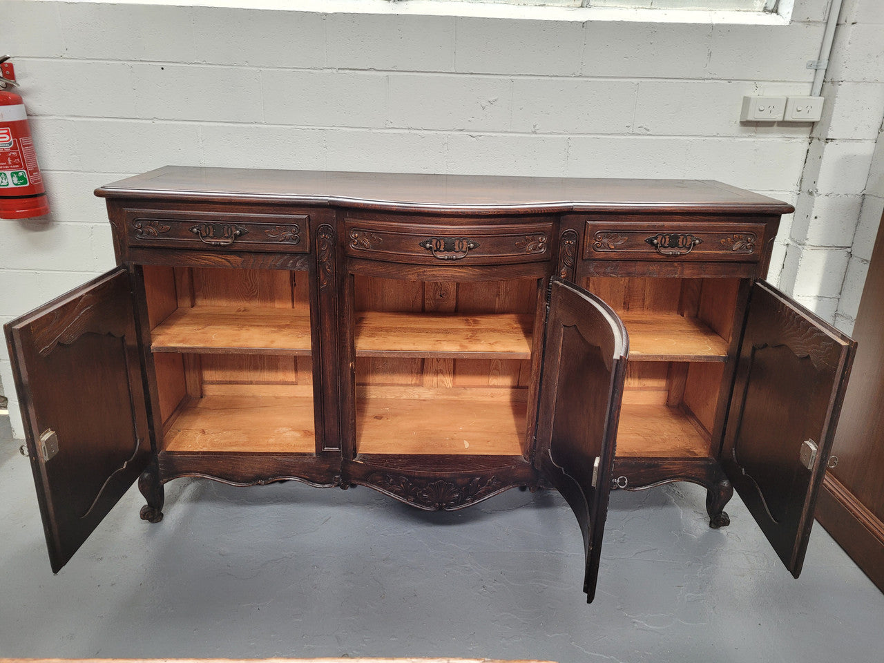 French dark oak three door and three drawer sideboard. Plenty of storage space and it is in good original detailed condition.